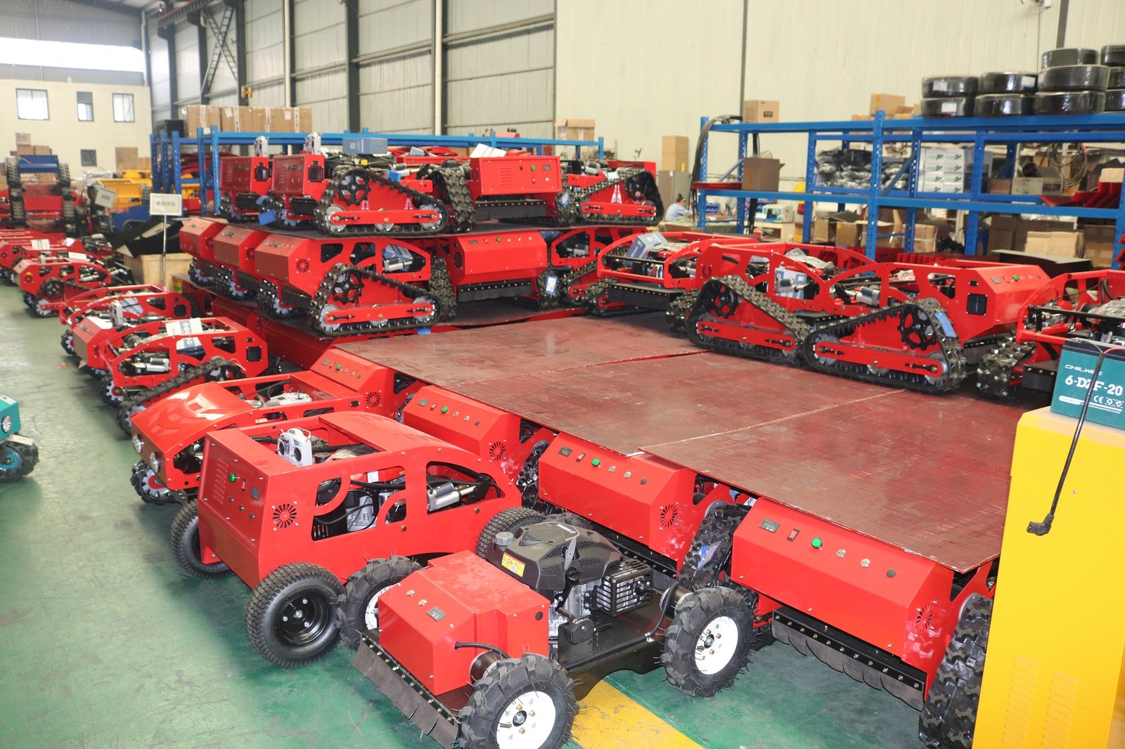 Red tractors and machinery in indoor warehouse