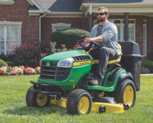 Man mowing lawn on John Deere E170 riding mower